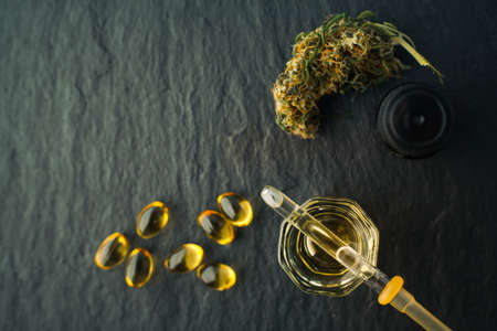 Cannabis bud and oil cbd on a dark, flat lay photo product hemp.の写真素材