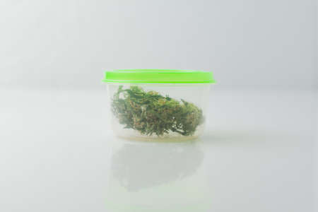 Cannabis bud in packaging on a white background. Medical cannabis drug.