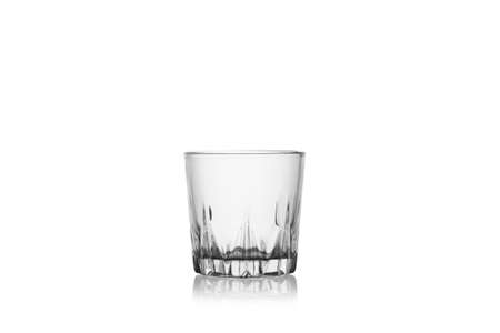 Empty whiskey glass isolated on a white background without glare. Reflection on the surface. Back light.の写真素材