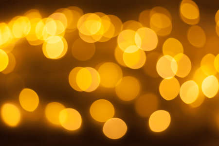 Festive garland bokeh background defocused. Background for greeting cards and postcards. Round bokeh...