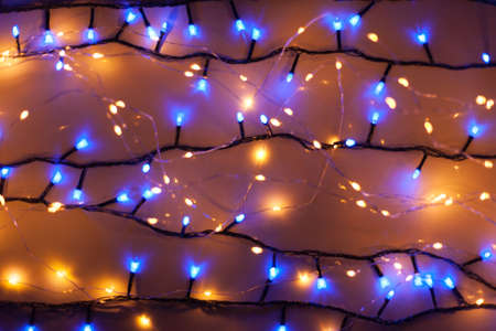 Christmas, festive background with glowing garland. Colorful lights on a dark background. New Year cards, postcard, banner. With space for text. Soft focus.の写真素材
