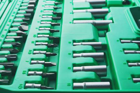 Mechanics Tool Set and Mechanic's Tool Box close-up. Plastic green Storage Box Case. Mechanics Tool Kit. Tool Box with Tools.の写真素材