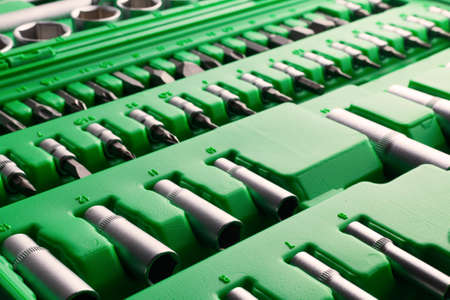 Mechanics Tool Set and Mechanic's Tool Box close-up. Plastic green Storage Box Case. Mechanics Tool Kit. Tool Box with Tools.の写真素材