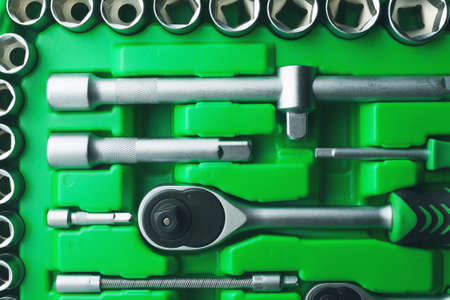 Mechanics Tool Set and Mechanic's Tool Box close-up. Plastic green Storage Box Case. Mechanics Tool Kit. Tool Box with Tools.の写真素材
