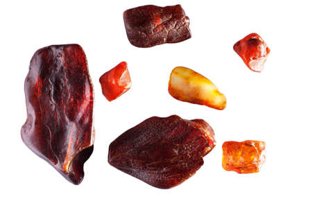 Raw amber stone or sun stone isolated on white background. A group of rough stones of various shapes.の写真素材
