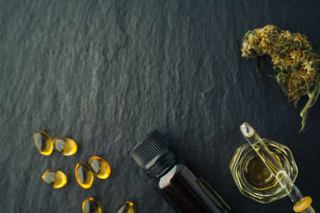 Cannabis bud and oil cbd on a dark, flat lay photo product hemp.の写真素材