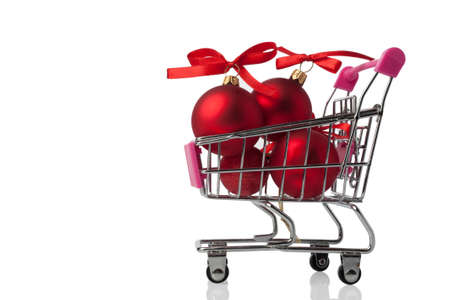 Shopping cart with Christmas toys isolated on white background.の写真素材