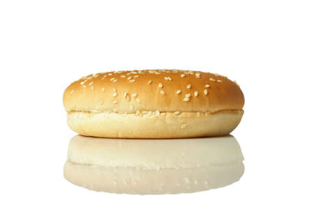Round burger bun with sesame seeds isolated on white background.の写真素材