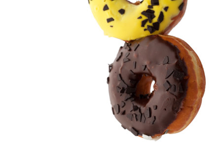 Appetizing levitating chocolate topping donuts isolated on white background.の写真素材