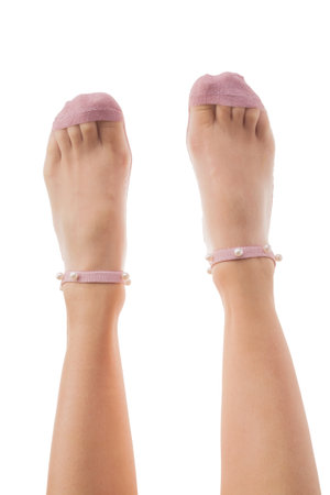 Female legs in transparent mesh socks isolated on white background. Pearls decoration.の写真素材