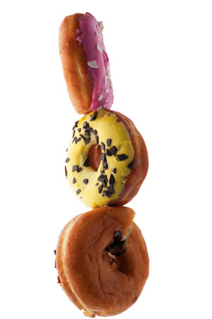 Appetizing donuts in glaze balance the stack on a white background.の写真素材