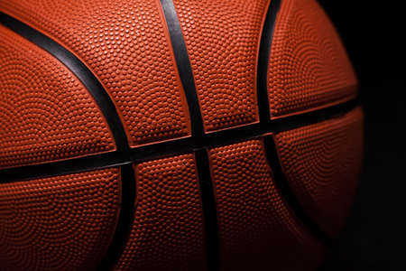 Basketball rubber orange ball close-up texture background.