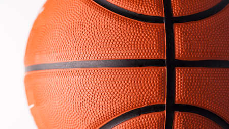 Basketball rubber orange ball close-up texture background.