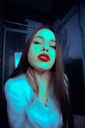 Beautiful young brown-haired girl art portrait on the balcony.の写真素材