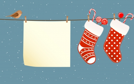 Christmas socks full of candies hanged on a clothesline next to a piece of paperのイラスト素材