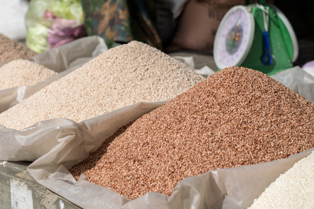Piles of red and white rice on a market in Bhutanの写真素材