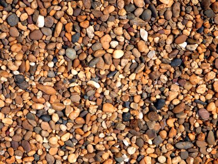 Pebble ground pattern, orange gravel floor material, brown soil surface, natural garden land backdrop, tan stone wall background, marble rock soil textureの写真素材