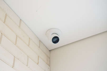 Security CCTV camera at ceiling in office building