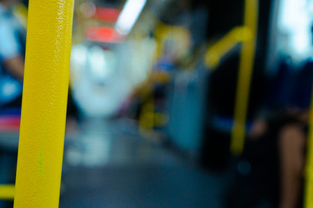 yellow poles for handrails in the interior of public transportation in the form of Transjakarta busesの写真素材