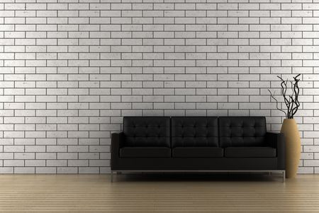 black sofa and vase with dry wood in front of brick wallの写真素材