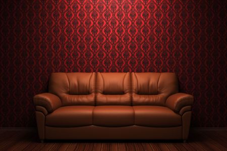 brown leather sofa in front of red wallの写真素材