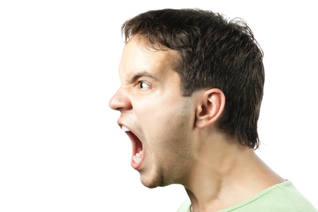 portrait of young angry man sreaming isolated on white backgroundの写真素材