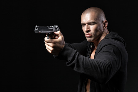 man shooting gun isolated on black background