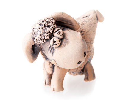 brown ceramic sheep statuette isolated on white backgroundの写真素材