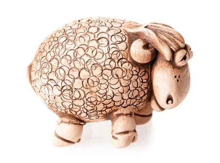 brown ceramic sheep statuette isolated on white backgroundの写真素材
