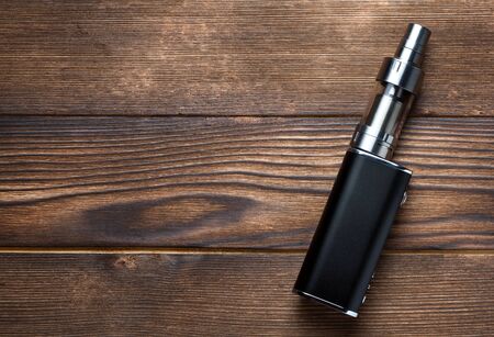 electronic cigarette on brown wooden backgroundの写真素材