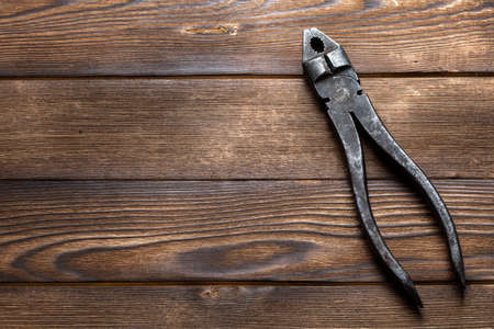 old rusty pliers on wooden backgroundの写真素材