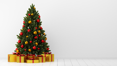 Decorated Christmas tree with gift boxes in white room.の写真素材