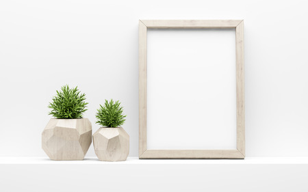 Wooden picture frame mock up and green potted plants on white shelf.の写真素材