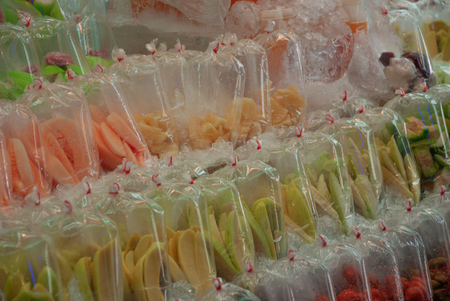 Market in Thailand,fresh fruit in a plastic bag, fresh fruit cut into a slices, ready to eatの写真素材