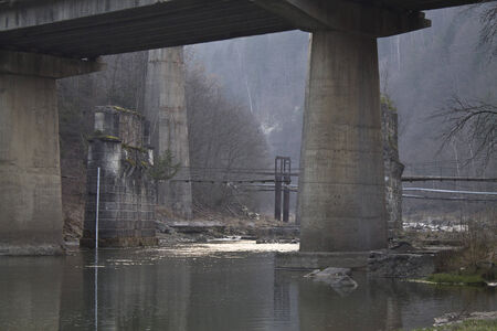 the railway bridge through the mountain riverの写真素材