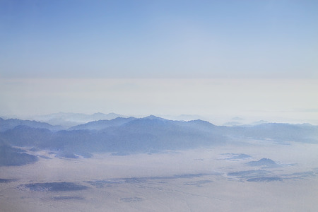The Egyptian desert and mountains from a plane windowの写真素材
