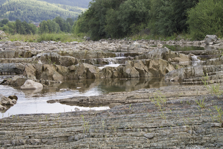 small mountain river flowing over rocksの写真素材