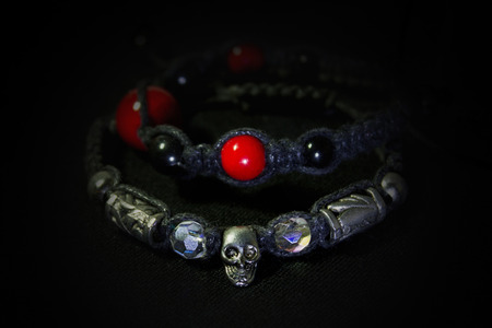 two braided bracelet closeup on black backgroundの写真素材