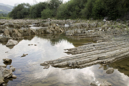 small mountain river flowing over rocks