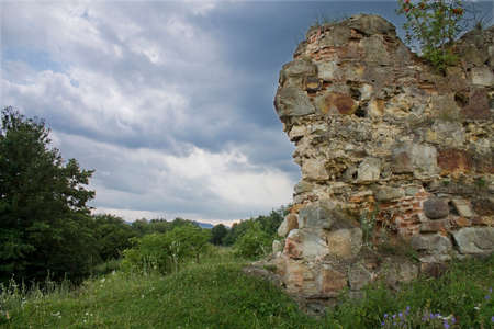 ruins of an ancient Ukrainian  castle on the background of stormy skyの写真素材