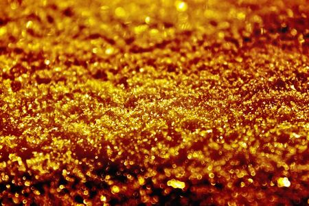golden blurred background with sparkles closeupの写真素材
