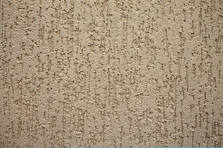 beige wall background with an abstract relief pattern closeupの写真素材