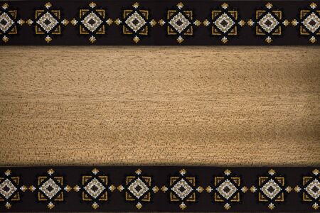 wooden background with brown patterned borderの写真素材