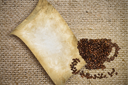 Cup of coffee beans on the background of burlapの写真素材