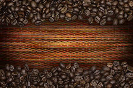 a border of coffee beans on a straw mat backgroundの写真素材
