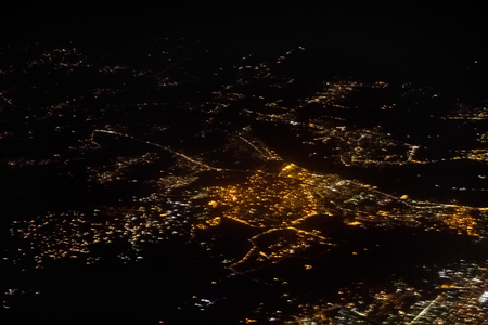 view from the airplane at the lights of the city at nightの写真素材
