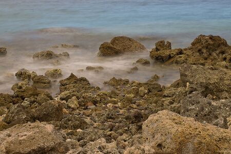 Marine rocky shore with waves removed at slow shutter speedsの写真素材