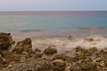 Marine rocky shore with waves removed at slow shutter speedsの写真素材
