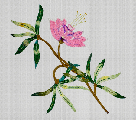 white background with embroidered pink flower closeupの写真素材