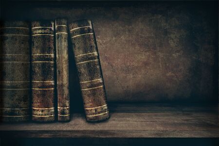 Vintage background with old books on a shelf and copy spaceの写真素材